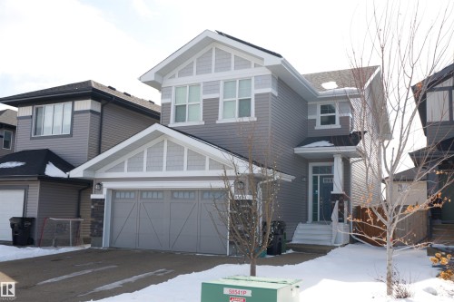 This property features a gray exterior with white trim, a double garage, and a front entry with a small porch - 20503 99 Avenue, Edmonton, AB - Outdoor With Facade