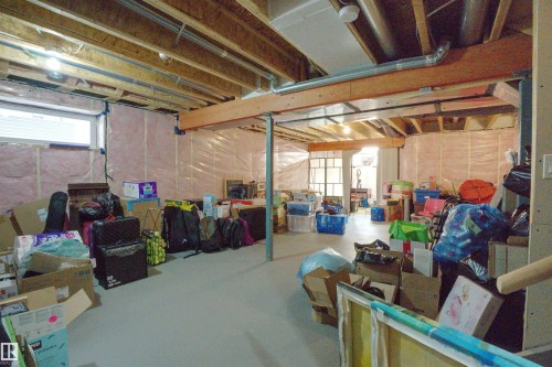 The property features an unfinished basement with exposed wooden beams, insulation, and concrete flooring, offering potential for future development - 20503 99 Avenue, Edmonton, AB - Indoor Photo Showing Basement