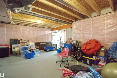 The property features an unfinished basement with exposed wooden joists and ductwork, providing an opportunity for customization - 20503 99 Avenue, Edmonton, AB - Indoor Photo Showing Basement