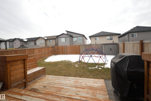 The property features a backyard with a wooden deck and privacy fencing - 20503 99 Avenue, Edmonton, AB - Outdoor With Exterior