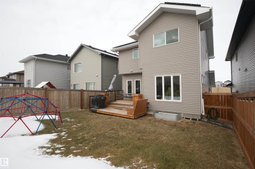 The property features a large yard with a wooden fence and a multi-level wooden deck - 20503 99 Avenue, Edmonton, AB - Outdoor With Exterior