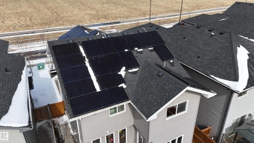 The property features solar panels installed on the roof and a fenced backyard - 20503 99 Avenue, Edmonton, AB - Outdoor