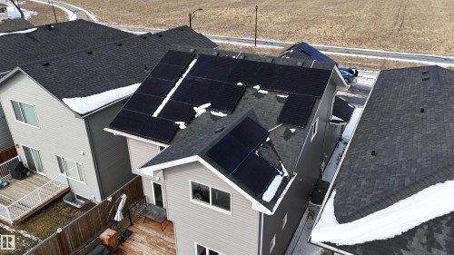 The property features a shingled roof with several solar panels installed - 20503 99 Avenue, Edmonton, AB - Outdoor