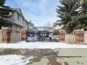 The complex features a fence with brick pillars and a wrought iron gate - 60 1128 156 Street, Edmonton, AB  - Outdoor With Deck Patio Veranda 
