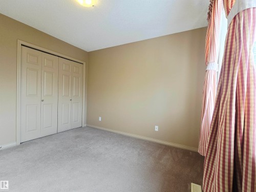 This room features wall-to-wall carpeting, a light-colored ceiling, and a flush-mount ceiling light fixture - 60 1128 156 Street, Edmonton, AB - Indoor Photo Showing Other Room