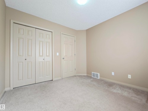 This bedroom features neutral-toned walls, light-colored carpeting - 60 1128 156 Street, Edmonton, AB - Indoor Photo Showing Other Room