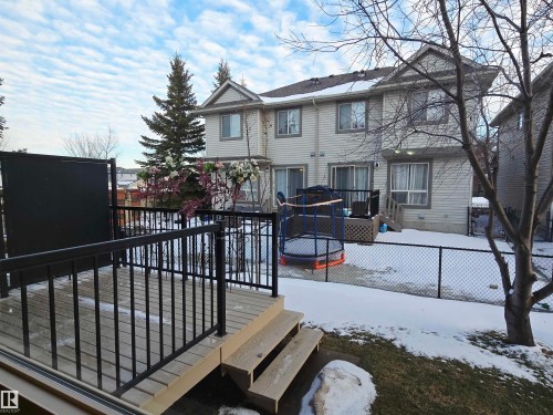 The property features a private yard with a chain link fence overlooking other properties - 60 1128 156 Street, Edmonton, AB - Outdoor With Deck Patio Veranda