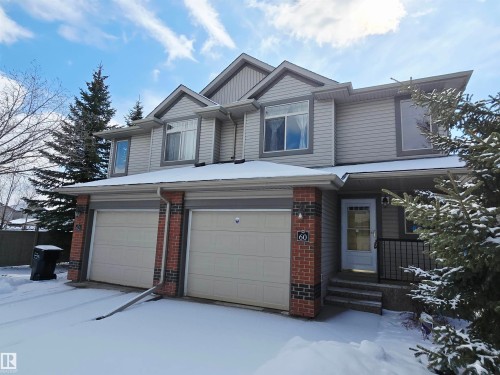 The property features a two-story exterior with light gray siding and brick accents - 60 1128 156 Street, Edmonton, AB - Outdoor With Facade