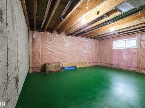 The property features an unfinished basement with exposed wooden joists and a window - 60 1128 156 Street, Edmonton, AB - Indoor Photo Showing Basement
