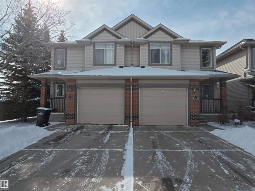 Side by side duplex with light-colored siding and brick accents - 60 1128 156 Street, Edmonton, AB - Outdoor With Facade