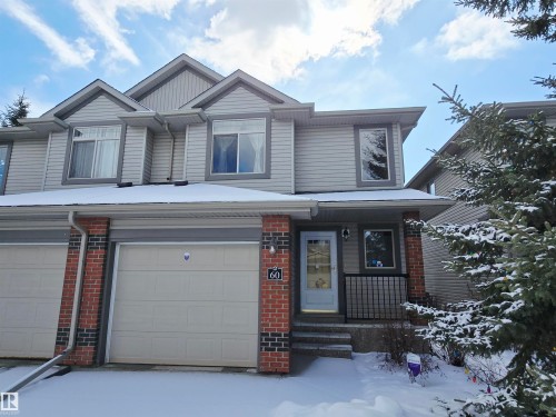 The property features a two-story exterior with light gray siding and brick accents, a gabled roofline, and an attached single-car garage - 60 1128 156 Street, Edmonton, AB - Outdoor With Facade