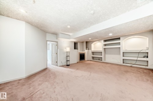 This room features plush carpet, recessed lighting, and built-in shelving units - 10631 181 Avenue, Edmonton, AB - Indoor Photo Showing Other Room