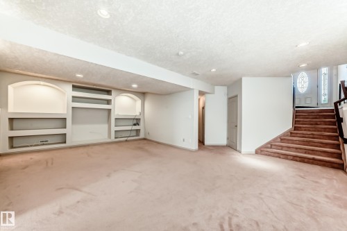 Spacious room featuring extensive built-in shelving, recessed lighting, and carpeted flooring - 10631 181 Avenue, Edmonton, AB - Indoor