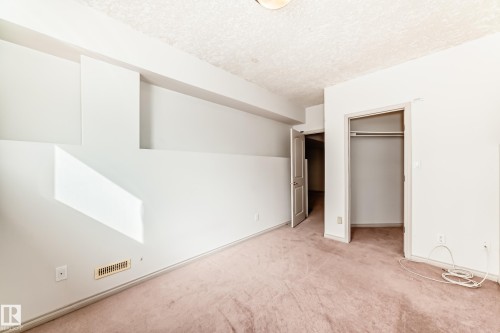 Room featuring white walls, carpeted flooring, and an open closet with a clothes hanging rod - 10631 181 Avenue, Edmonton, AB - Indoor Photo Showing Other Room