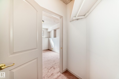 The property features a room with light-colored carpeting, a window, and a light fixture on the ceiling - 10631 181 Avenue, Edmonton, AB - Indoor Photo Showing Other Room