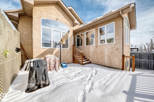 The property features a stucco exterior with multiple windows, including a large arched window - 10631 181 Avenue, Edmonton, AB - Outdoor With Exterior