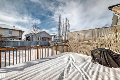 The property features a wooden deck with a lattice privacy screen - 10631 181 Avenue, Edmonton, AB - Outdoor With Deck Patio Veranda With Exterior