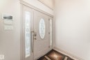 The entry features a white door with an oval-shaped glass insert, flanked by two sidelight windows with decorative glass - 10631 181 Avenue, Edmonton, AB  - Indoor Photo Showing Other Room 