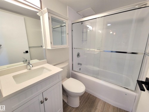 Recently renovated bathroom with new flooring, paint and quartz counter with under-mount sink - 804 9028 Jasper Avenue, Edmonton, AB - Indoor Photo Showing Bathroom