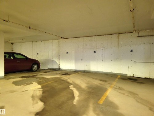 Underground parking space with designated yellow parking lines - 804 9028 Jasper Avenue, Edmonton, AB - Indoor Photo Showing Garage