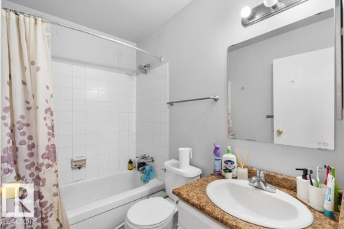 Bathroom with a bathtub and shower combination, white tiled walls, and a vanity with a granite-style countertop and an oval sink - 638 Saddleback Road, Edmonton, AB - Indoor Photo Showing Bathroom