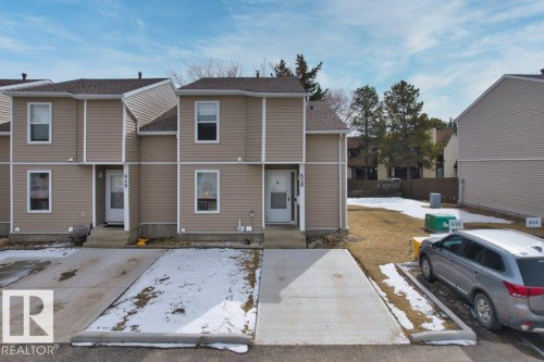 The property features a two-story structure with tan siding and a dark roof - 638 Saddleback Road, Edmonton, AB - Outdoor With Facade
