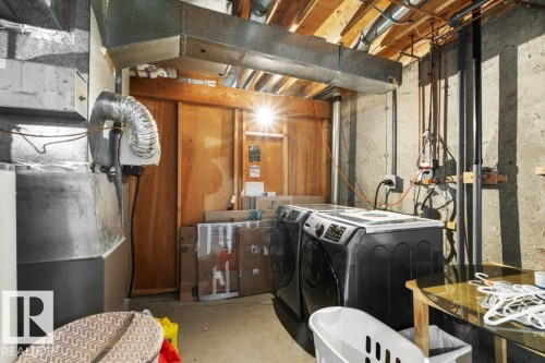 The utility area features exposed ceiling joists, concrete walls, and visible ductwork - 638 Saddleback Road, Edmonton, AB - Indoor Photo Showing Laundry Room