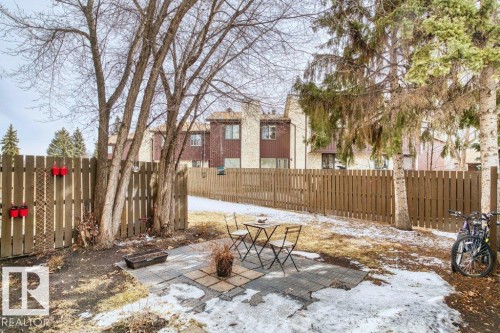 The property features a fenced backyard with mature trees - 638 Saddleback Road, Edmonton, AB - Outdoor