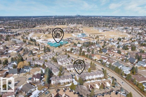 Aerial view showcasing the surrounding neighborhood, featuring residential properties, mature trees, and local amenities under a clear sky - 638 Saddleback Road, Edmonton, AB - Outdoor With View