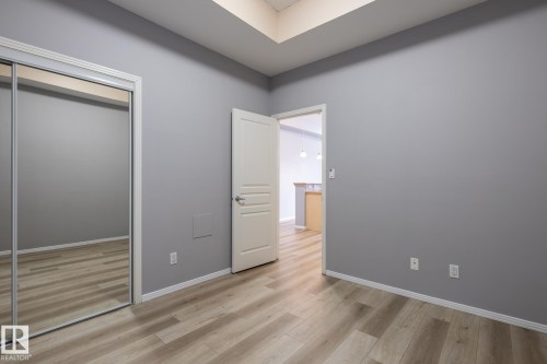 Room with light wood-style flooring and light gray walls - 210 10147 112 Street, Edmonton, AB - Indoor Photo Showing Other Room