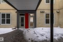 The property features a stucco exterior with multiple windows and two entry doors - 210 10147 112 Street, Edmonton, AB  - Outdoor With Exterior 
