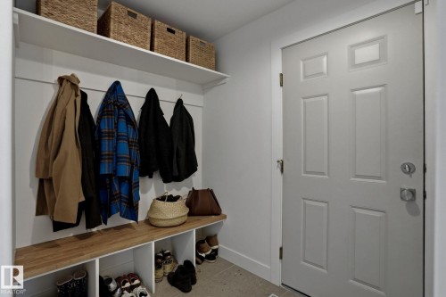 Functional mudroom with a built-in bench, storage cubbies, and a shelf with woven baskets - 9228 100 Avenue, Edmonton, AB - Indoor Photo Showing Other Room