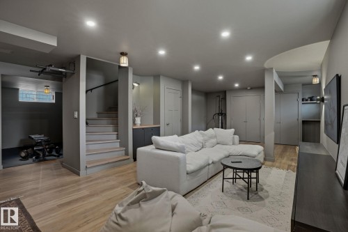 This spacious room features light-colored wood flooring and recessed lighting throughout, creating a bright and inviting atmosphere - 9228 100 Avenue, Edmonton, AB - Indoor Photo Showing Other Room