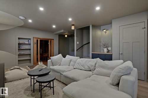 This living space features recessed lighting, a built-in bookshelf, and a door with horizontal paneling - 9228 100 Avenue, Edmonton, AB - Indoor