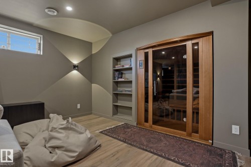 The property features an interior room with a wooden sauna, built-in shelving, and light wood-style flooring - 9228 100 Avenue, Edmonton, AB - Indoor Photo Showing Other Room