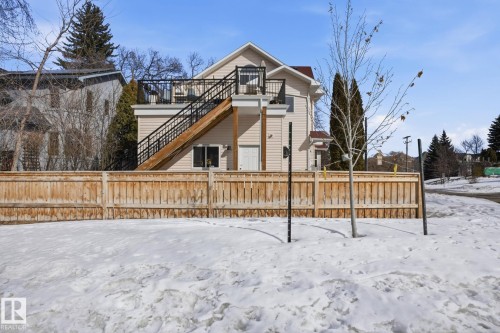 The property features a private fenced yard with a large wooden fence - 9228 100 Avenue, Edmonton, AB - Outdoor