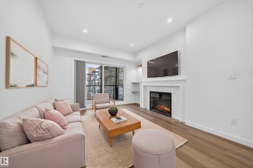 Virtually Staged - 301 7459 May Common, Edmonton, AB - Indoor Photo Showing Living Room With Fireplace