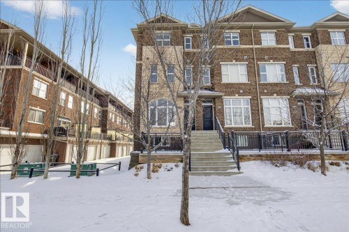 Exterior view of the property, featuring a brick facade, white window frames, and a stone staircase leading to the main entrance - 2105 Casselman Link Link, Edmonton, AB - Outdoor With Facade