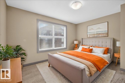 Bedroom featuring carpeted flooring, a window with blinds, and a ceiling light fixture - 2105 Casselman Link Link, Edmonton, AB - Indoor Photo Showing Bedroom