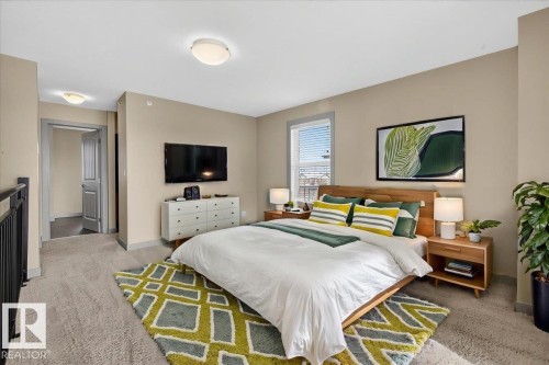 This room features neutral-toned walls, carpeting, and a window with blinds - 2105 Casselman Link Link, Edmonton, AB - Indoor Photo Showing Bedroom