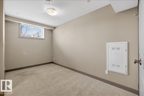 This room features neutral-toned walls, a window with blinds, and light-colored carpeting - 2105 Casselman Link Link, Edmonton, AB - Indoor Photo Showing Other Room