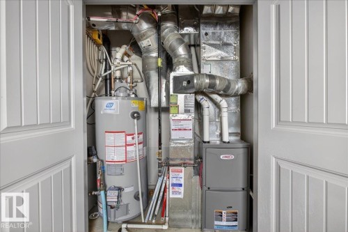 Utility closet featuring a water heater and furnace - 2105 Casselman Link Link, Edmonton, AB - Indoor Photo Showing Basement