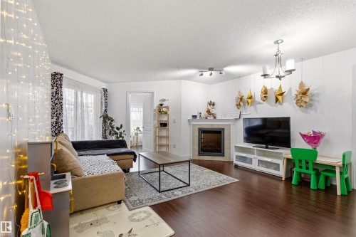 224 2045 Grantham Court, Edmonton, AB - Indoor Photo Showing Living Room With Fireplace