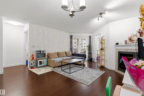 224 2045 Grantham Court, Edmonton, AB - Indoor Photo Showing Living Room With Fireplace