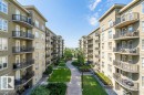 The property features a well-maintained courtyard with established green lawns and mature landscaping - 1-204 4245 139 Avenue, Edmonton, AB  - Outdoor With Balcony 