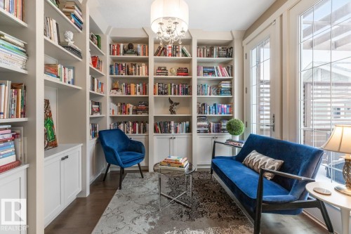 Den, Office, or Library - the Choice is Yours! Located just off the Living Room, Featuring Custom Built in Cabinets and West Facing Patio Doors leading to a Manicured Backyard - 7432 Colonel Mewburn Road, Edmonton, AB - Indoor Photo Showing Office
