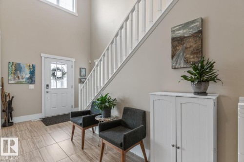 Entryway to the Home featuring Maple Hardwood Flooring and Open to Below Ceiling - 7432 Colonel Mewburn Road, Edmonton, AB - Indoor Photo Showing Other Room