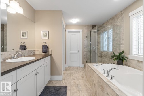 5 Piece Ensuite featuring Upgraded Glass Shower, Soaker Tub, Double Sink Vanity, Water Closet, and Walk In Closet - 7432 Colonel Mewburn Road, Edmonton, AB - Indoor Photo Showing Bathroom