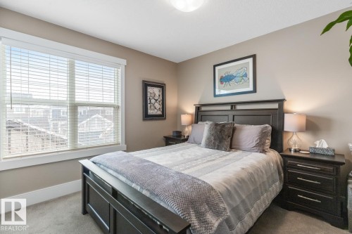 Additional Bedroom located on the Second Floor with West Facing Windows overlooking a Manicured Lawn - 7432 Colonel Mewburn Road, Edmonton, AB - Indoor Photo Showing Bedroom