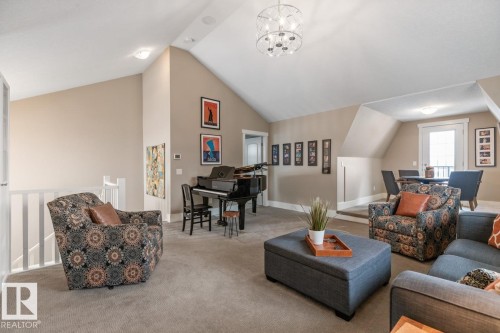 3rd Floor Bonus Room featuring East Facing Windows, a West Facing Juliet Balcony, and 4 Piece Bathroom - 7432 Colonel Mewburn Road, Edmonton, AB - Indoor Photo Showing Living Room